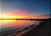 A beautiful sunset at Cape Charles beach, with the fishing pier 
