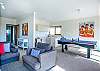 Kitchenette, table tennis/ pool table, lounge, TV, sliding glass doors and the beach across the road. 