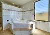 The spectacular ensuite has a two-person corner spa bath