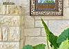 Sublime close up of the white stone walls, rock decor and tropical plants.