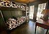 Buck a Roo bedroom 7 has twin bunk beds, french doors, private covered patio & ensuite spa-like bath. 