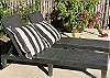 Poolside relaxation lounge chairs with cushions.