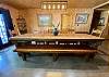 Custom dining table, cowhide chairs and massive bench seating.