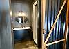 Bedroom 7 has ensuite bathroom with floating vanity, white shower & vaulted ceiling.