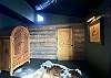 Bed 6 - Mexican armoire, antique wood wall and original art with picture light.