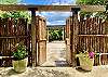 Step under 6,000 lbs timber beams and thru 200 year old doors to the tropical garden, massive flagstone courtyard & Party Pavilion.