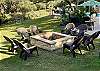 Custom rock fire pit with lots of chairs.
