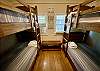 The Barn bedroom has 2 sturdy twin bunk beds, wood floors, vaulted ceiling and private field views.
