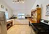 Kitchen #1 is fully stocked, gas stove, stainless appliances, vaulted ceiling and tile floor.