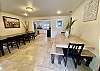 Large dining room has tile floors and upscale dining tables that comfortably seat 18.