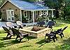 White rock fire pit with lots of comfortable chairs.