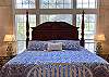 King sized Plantation Bed is picture perfect with views of the pool and mountains.