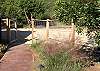 HIGH FENCED, ROCK PATHWAYS, PROFESSIONAL LANDSCAPING IN THE BACKYARD.