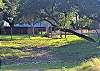 THE VIEW FROM THE FRIO RIVER LOOKING BACK AT THE HOUSE.