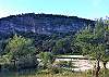 BACK YARD IS THE FRIO RIVER WITH LARGE SLABS OF ROCK UNDER THE MOUNTAIN.