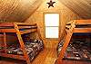 2 sets of bunkbeds with twin on top and doubles on bottom.  Wood floors, vaulted ceiling and en suite bathroom.