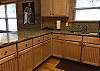 Kitchen has plenty of custom cabinets, granite counter tops for preparing food.