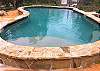 Custom raised edge pool, rock patio, high fenced, private, mountain views, cabana, upscale patio furniture.