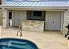 OUT DOOR CABANA BATHROOM AND STORAGE.  KITCHEN HAS FRIG, BIG SMART TV, AND COOL TRACTOR SEATS.