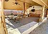 Outdoor entertainment area has plenty of rock ledge seating, gas bbq and charcoal smoker.