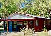 IN THE HEART OF CONCAN ON RIVER ROAD ACROSS FROM THE FRIO RIVER IS HIPPIE HUT.