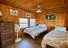 An alcove upstairs has 2 twin beds and camp style decor.