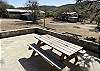 Outside there's a picnic table with rock wall overlooking the views.