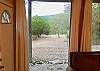 The living room is a wall of windows with mountain and river views.