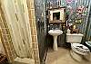 BATHROOM 2 HAS TIN ON THE WALL, TILE FLOOR AND TILE SHOWER. CHECK OUT THE CRAZY WALL ART.
