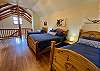 Bedroom 3 is an open loft with stunning architectural details.