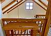 Views from upstairs looking at the beautiful woodwork, cedar railing and wooden beams.