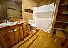 Upstairs bathroom has wood floors, custom cedar cabinets and lots of storage.