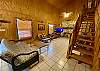 40' Vaulted living room ceiling, white tile floor, rock fireplace.