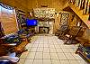 Living room has cedar staircase leading to the upstairs loft.