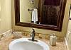 Master Bedroom ensuite bathroom has tile counters, handsome stone toiletries and shower.