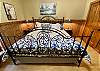 Romantic bedroom 2 has a wrought iron King bed, upscale furnishings and twin trundle bed.