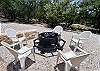 A 2nd wood burning fire pit with chairs.
