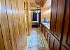 Floor to ceiling custom cabinetry leads to the luxurious master bathroom.