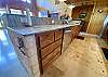 Center kitchen island has dishwasher and griddle.