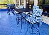 Blue tile highlights the sky and aqua marine pool below.