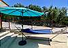 Umbrella provides shade for the poolside hammock.