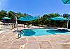 Huge flagstone deck surrounds pool.