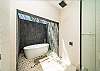 The master's bedroom has an en-suite bathroom that includes a full separate shower, double sink, and an open-air private bathtub.
