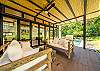 A shaded terrace that opens to the patio and green areas where you can enjoy the views to the garden and pool area