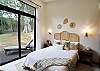 1 Queen-sized bedroom that includes a terrace that opens to the patio and green areas.