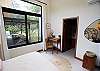 Second Queen-sized bedroom with a private bathroom and a window facing the green areas