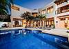 Twilight at Casa Milagro's resort pool. Experience seamless luxury with private chef catering, poolside cocktails, sunset catamaran charters, and VIP transfers.