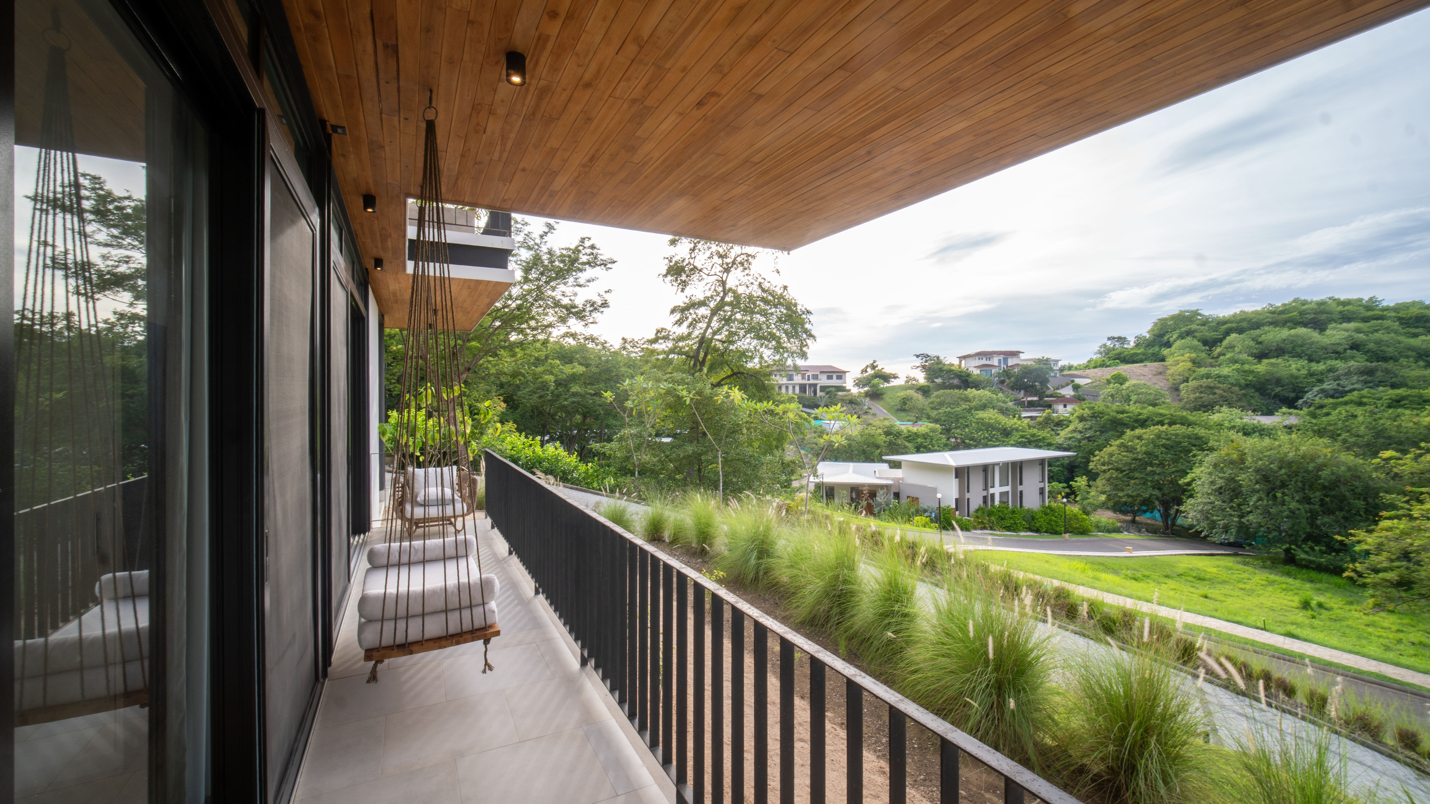 Terrace with comfortable chairs overlooking green hills
