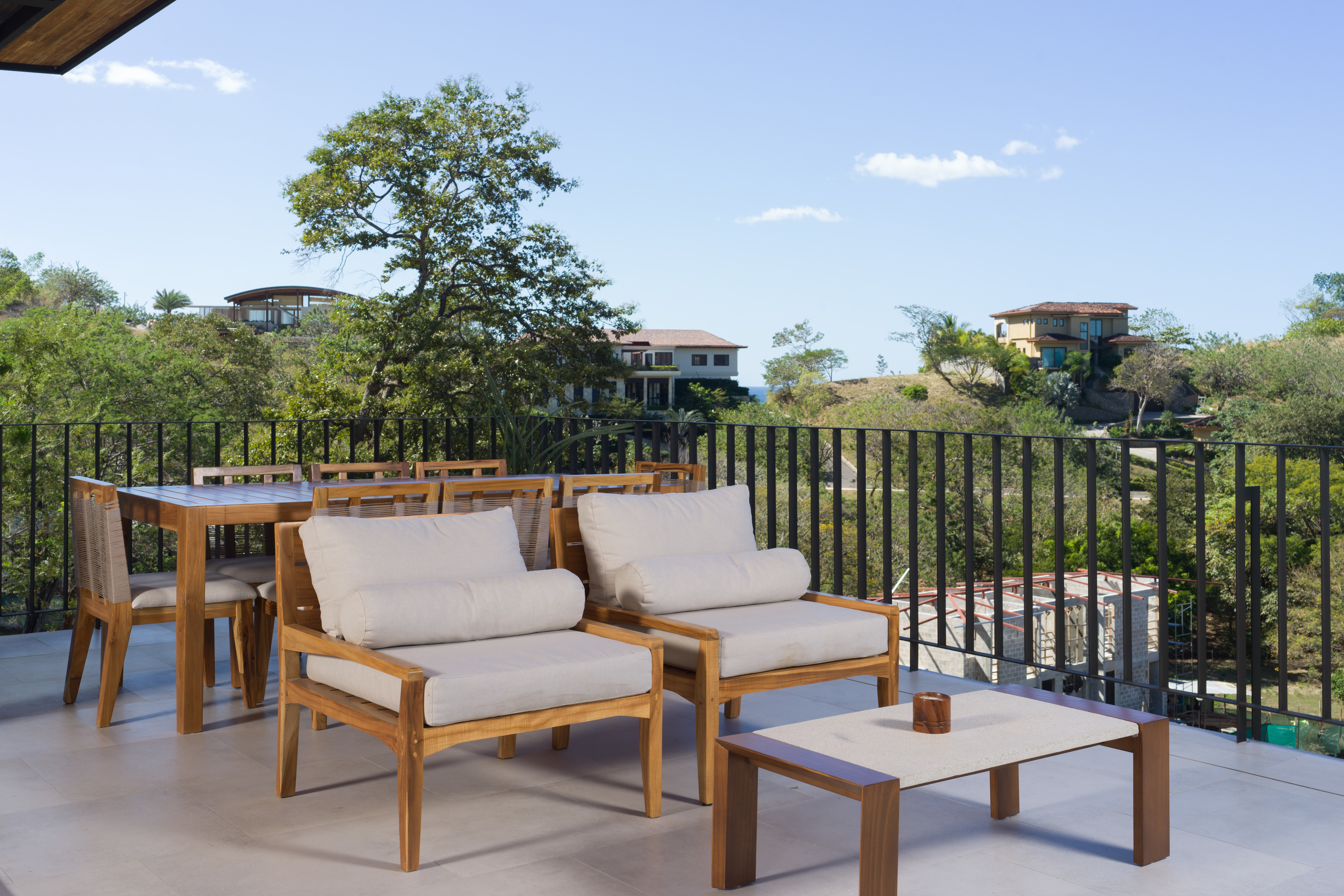 Rooftop terrace dining area surrounded by greenery