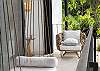 A serene, stylish balcony retreat featuring natural textures, cozy seating, and a relaxed, modern tropical vibe. 